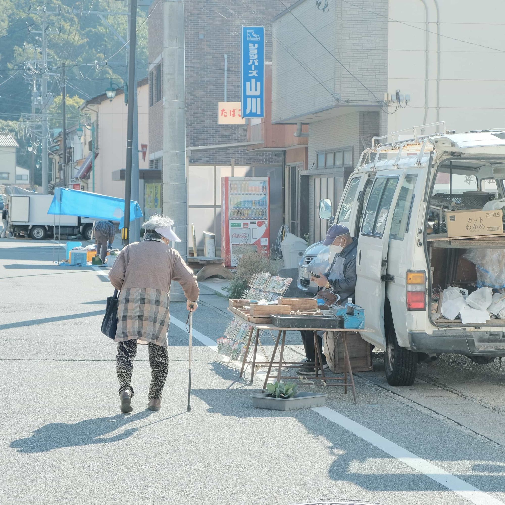 A seller selling something out of a van